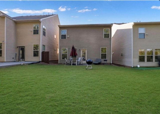 rear view of property with a lawn