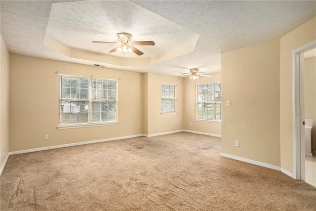 4103 Kingship Dr, Ellenwood, GA 30294 - carpeted spare room with a textured ceiling, a ceiling fan, a tray ceiling, and baseboards
