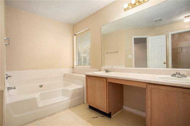 4103 Kingship Dr, Ellenwood, GA 30294 - full bath with double vanity, a bath, and a textured ceiling