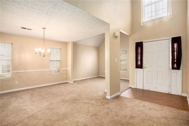 4103 Kingship Dr, Ellenwood, GA 30294 - foyer entrance with carpet floors, a chandelier, baseboards, and a textured ceiling