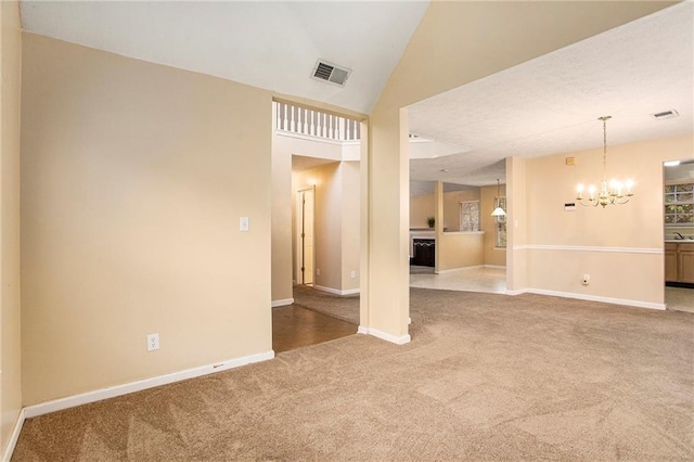 4103 Kingship Dr, Ellenwood, GA 30294 - unfurnished living room featuring carpet, a chandelier, baseboards, a fireplace, and lofted ceiling