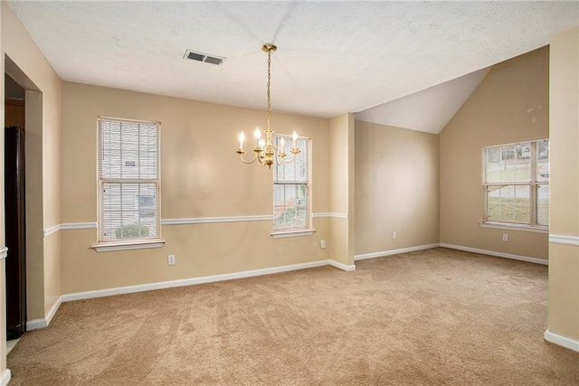 4103 Kingship Dr, Ellenwood, GA 30294 - empty room featuring carpet floors, a chandelier, healthy amount of natural light, lofted ceiling, and a textured ceiling
