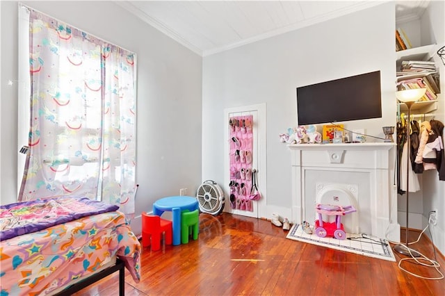 bedroom featuring wood finished floors and ornamental molding