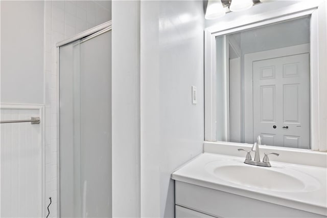 full bath with an enclosed shower and vanity