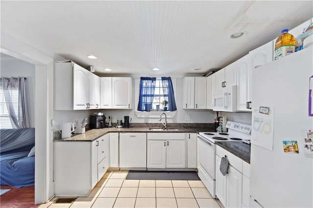 kitchen featuring a sink, white appliances, and white cabinets