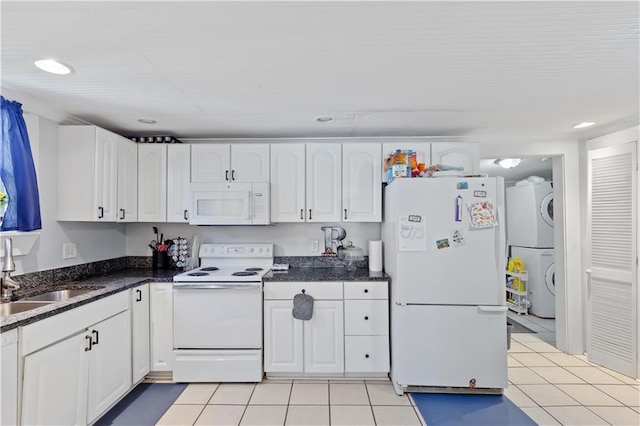 kitchen featuring stacked washer / dryer, white cabinets, white appliances, and a sink