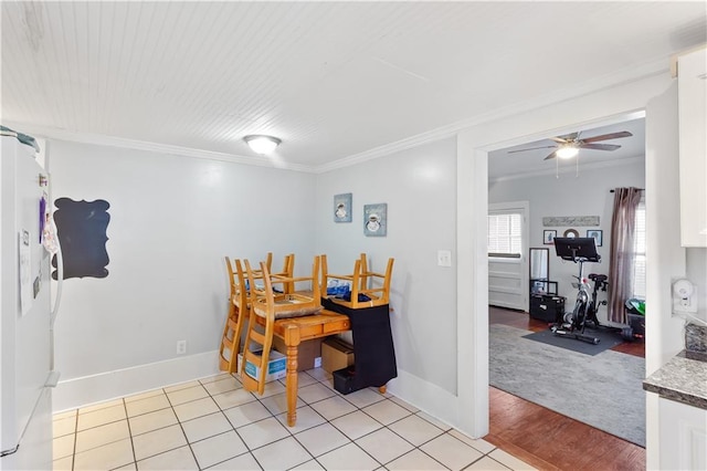 dining room with light tile patterned floors, baseboards, a ceiling fan, and ornamental molding