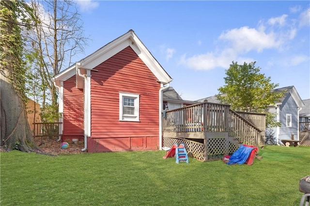 view of home's exterior featuring a wooden deck, a yard, and fence