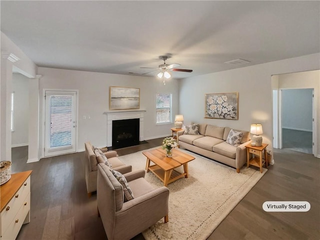 living room with dark hardwood / wood-style flooring and ceiling fan