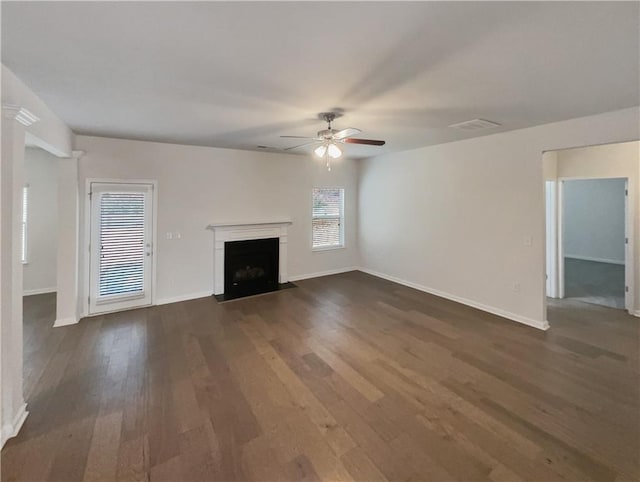 unfurnished living room featuring ceiling fan and dark hardwood / wood-style flooring