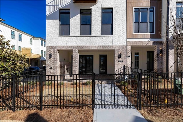 350 Olmstead Way Unit 29, Alpharetta, GA 30022 - view of property featuring a fenced front yard, brick siding, and a porch