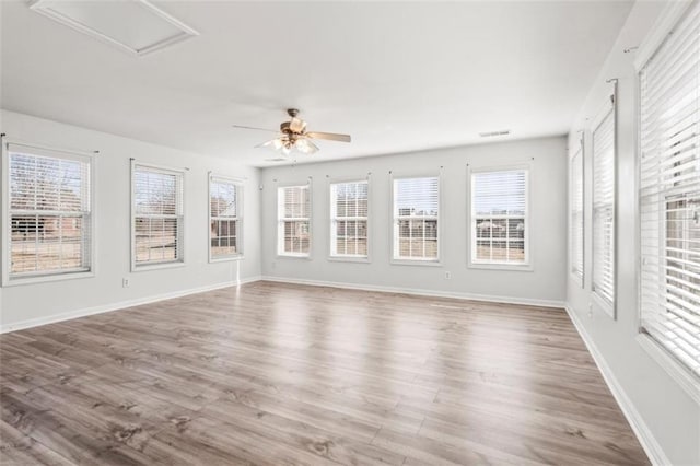 unfurnished sunroom with visible vents and ceiling fan