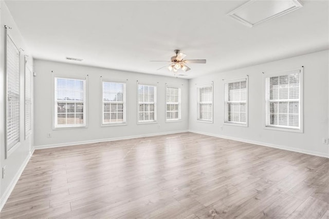 unfurnished sunroom featuring visible vents and a ceiling fan