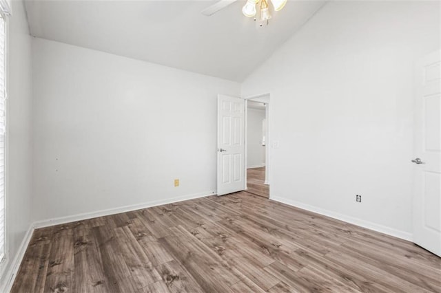 unfurnished bedroom with light wood-style floors, high vaulted ceiling, baseboards, and a ceiling fan