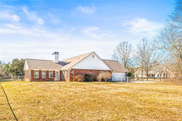 view of front of house featuring fence private yard, a chimney, a front lawn, and brick siding