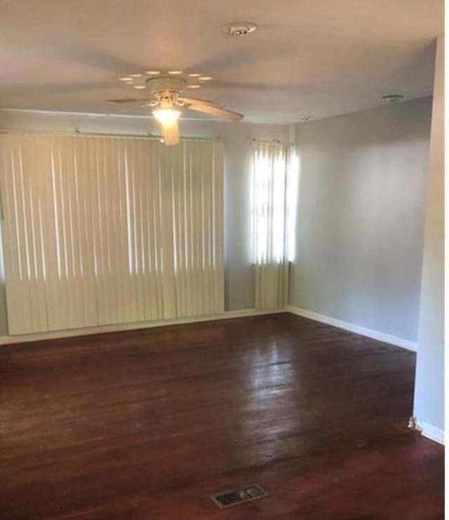 spare room featuring ceiling fan and dark hardwood / wood-style flooring