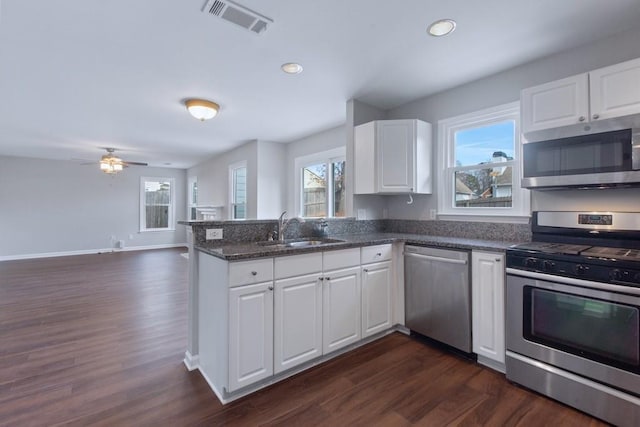 kitchen featuring white cabinetry, sink, stainless steel appliances, and plenty of natural light