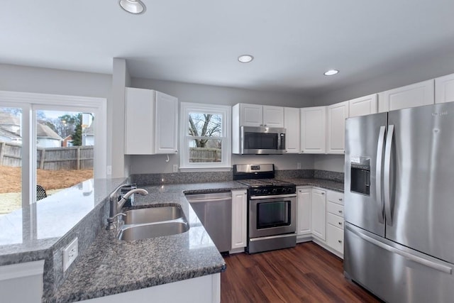 kitchen featuring white cabinets, plenty of natural light, and stainless steel appliances