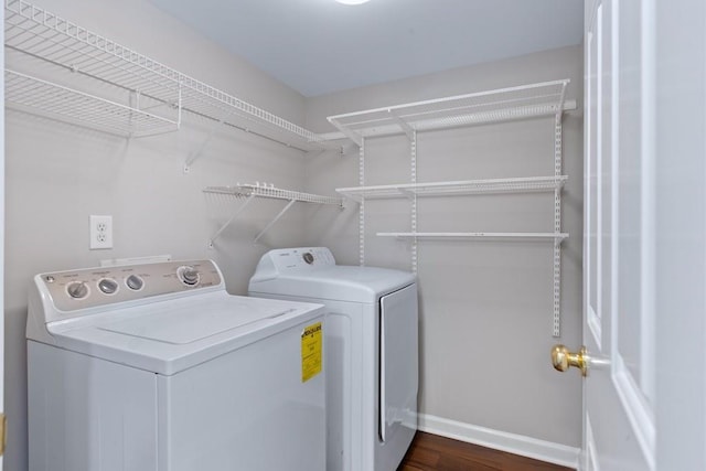 washroom featuring washing machine and dryer and dark hardwood / wood-style floors