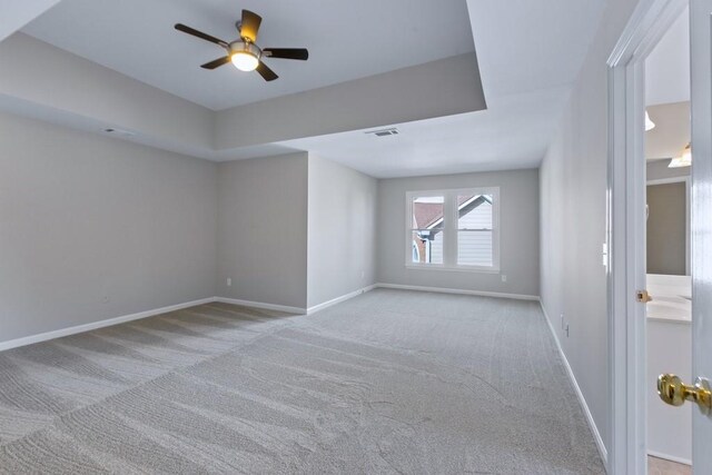 carpeted spare room with ceiling fan