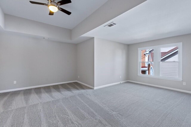 empty room with carpet floors and ceiling fan