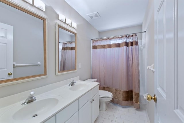 bathroom featuring tile patterned flooring, vanity, toilet, and curtained shower