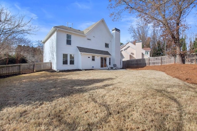 back of house featuring a lawn