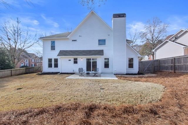 back of house with a yard and a patio area