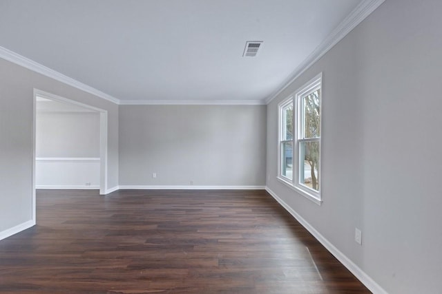 spare room with crown molding and dark wood-type flooring