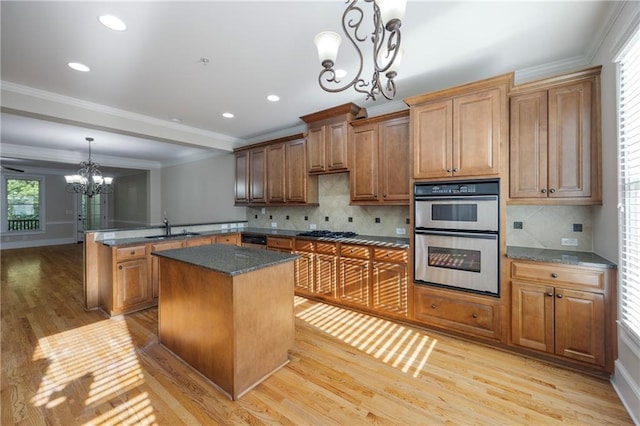 4742 Legacy Cove Ln, Smyrna, GA 30126 - kitchen with a chandelier, double oven, a peninsula, light wood-style floors, and black gas stovetop