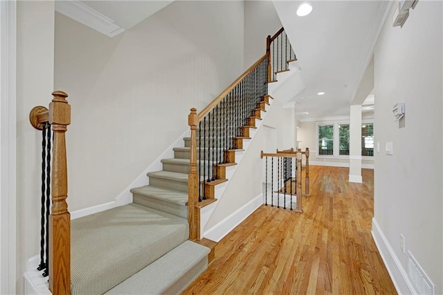 4742 Legacy Cove Ln, Smyrna, GA 30126 - staircase with wood finished floors, crown molding, and recessed lighting
