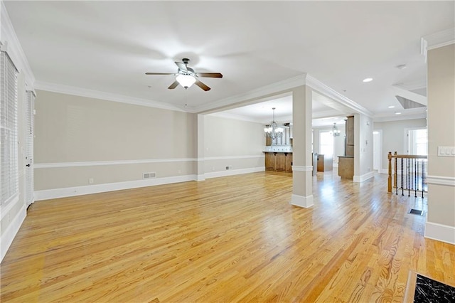 4742 Legacy Cove Ln, Smyrna, GA 30126 - unfurnished living room with a chandelier, a ceiling fan, light wood-style flooring, ornamental molding, and recessed lighting