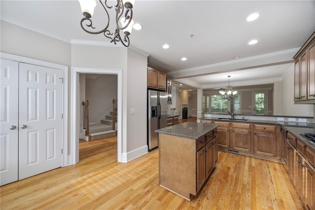 4742 Legacy Cove Ln, Smyrna, GA 30126 - kitchen with a chandelier, stainless steel refrigerator with ice dispenser, ornamental molding, light wood-style floors, and brown cabinets