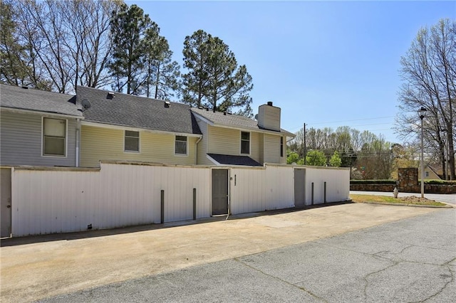 4322 Idlewood Ln, Tucker, GA 30084 - view of side of property featuring a chimney and roof with shingles