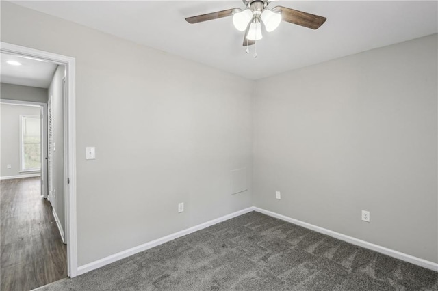 4322 Idlewood Ln, Tucker, GA 30084 - unfurnished room featuring baseboards, dark carpet, and a ceiling fan