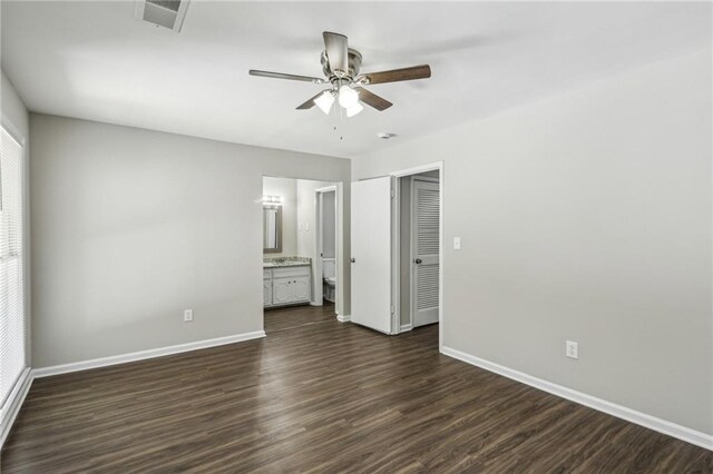 4322 Idlewood Ln, Tucker, GA 30084 - unfurnished bedroom featuring baseboards, dark wood-style floors, ensuite bath, ceiling fan, and visible vents