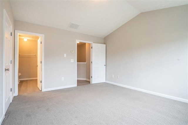 2709 Heathrow Dr, Lawrenceville, GA 30043 - unfurnished bedroom with carpet flooring, baseboards, and lofted ceiling