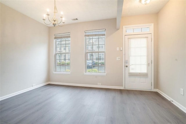 2709 Heathrow Dr, Lawrenceville, GA 30043 - foyer entrance featuring a chandelier, dark wood-style floors, baseboards, and a textured ceiling