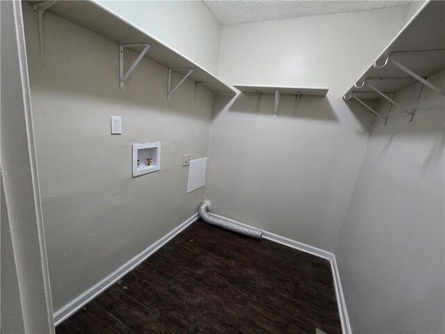 washroom with dark hardwood / wood-style flooring and washer hookup