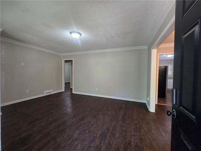 unfurnished room with a textured ceiling, dark hardwood / wood-style floors, and ornamental molding