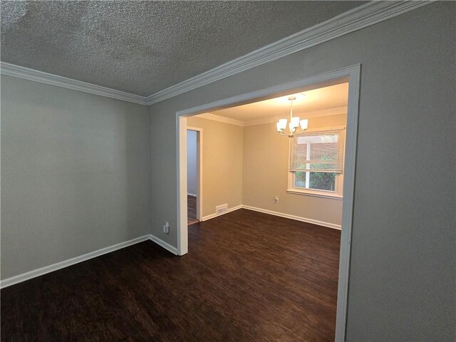 unfurnished room featuring a textured ceiling, dark hardwood / wood-style flooring, an inviting chandelier, and crown molding