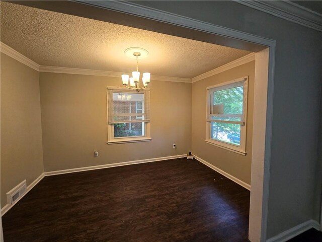 unfurnished room with a textured ceiling, dark hardwood / wood-style flooring, crown molding, and a chandelier