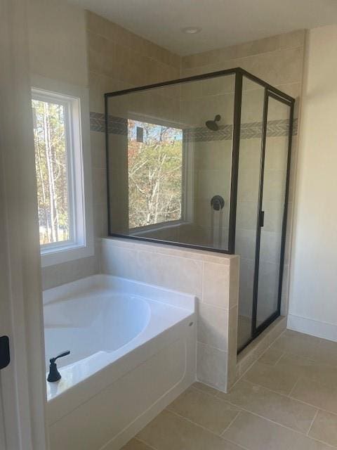 full bathroom with tile patterned floors, a shower stall, and a garden tub