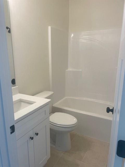 bathroom featuring tile patterned floors, shower / tub combination, toilet, and vanity