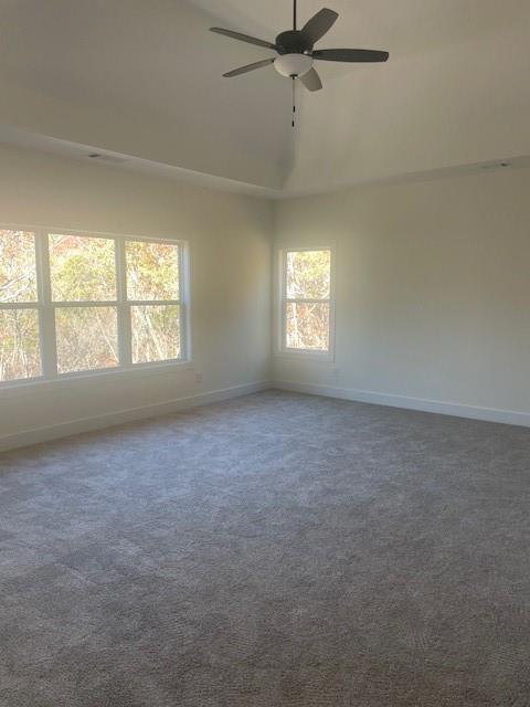 unfurnished room with carpet, baseboards, and ceiling fan