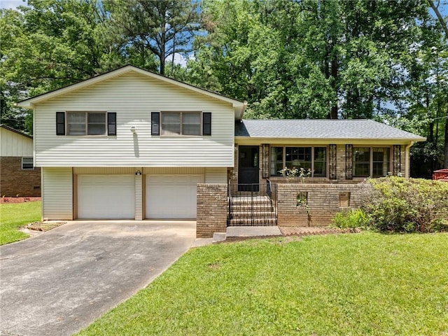 784 San Miguel Dr, Stone Mountain, GA 30083 - tri-level home with a front lawn, driveway, a garage, brick siding, and a shingled roof