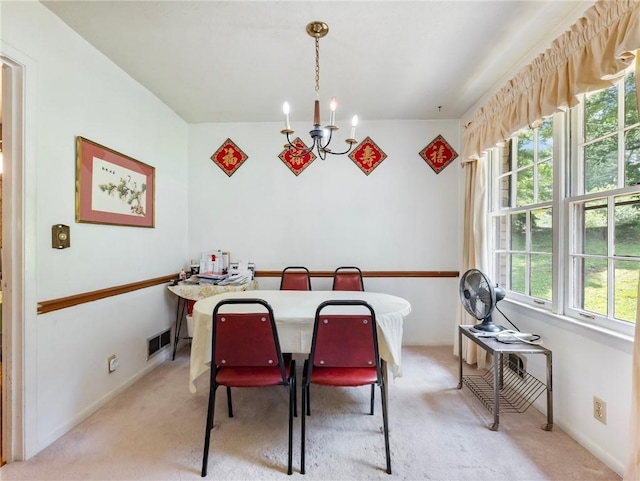 784 San Miguel Dr, Stone Mountain, GA 30083 - dining room featuring a chandelier and light colored carpet