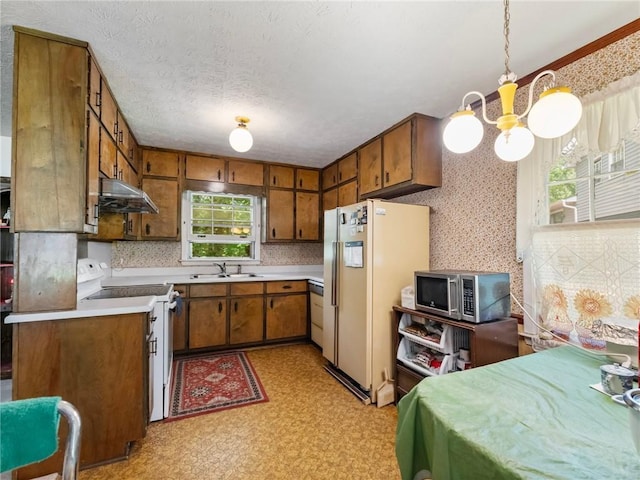 784 San Miguel Dr, Stone Mountain, GA 30083 - kitchen with white appliances, a chandelier, brown cabinetry, under cabinet range hood, and light countertops