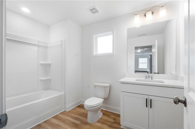 full bath featuring vanity, wood finished floors, visible vents, baseboards, and toilet