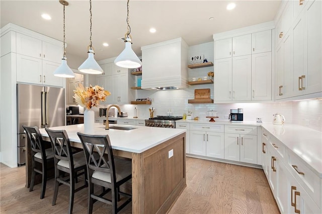 920 Wemberley Ln, Marietta, GA 30064 - kitchen featuring high end fridge, open shelves, a sink, light wood-type flooring, and tasteful backsplash